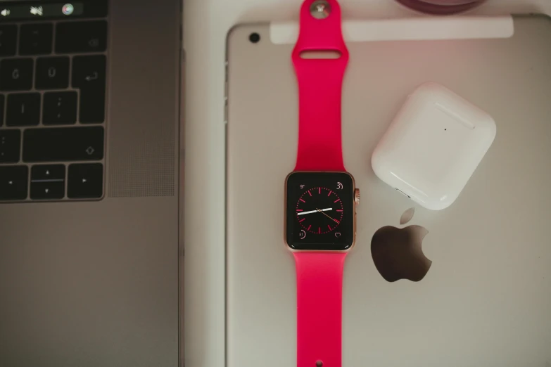 a pink apple watch sitting on top of a table, a photo, laptops, ((pink)), silicone skin, thumbnail