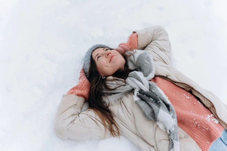 a woman laying in the snow with her eyes closed, pexels contest winner, confident relaxed pose, profile image, looking upwards, wearing a scarf