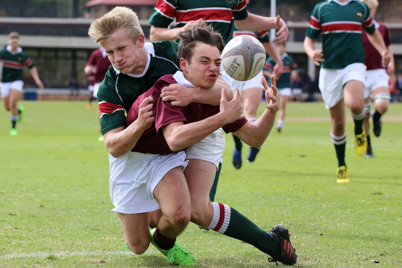 a group of young men playing a game of soccer, a photo, pixabay, maroon and white, lachlan bailey, biting lip, side profile shot