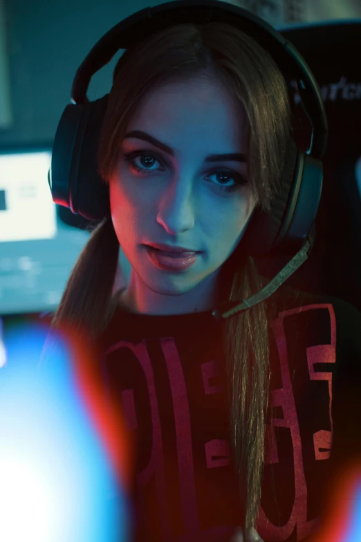 a woman wearing headphones sitting in front of a computer, a portrait, inspired by Julia Pishtar, featured on reddit, team ibuypower, close up portrait shot, gaming room, cinematic outfit photo