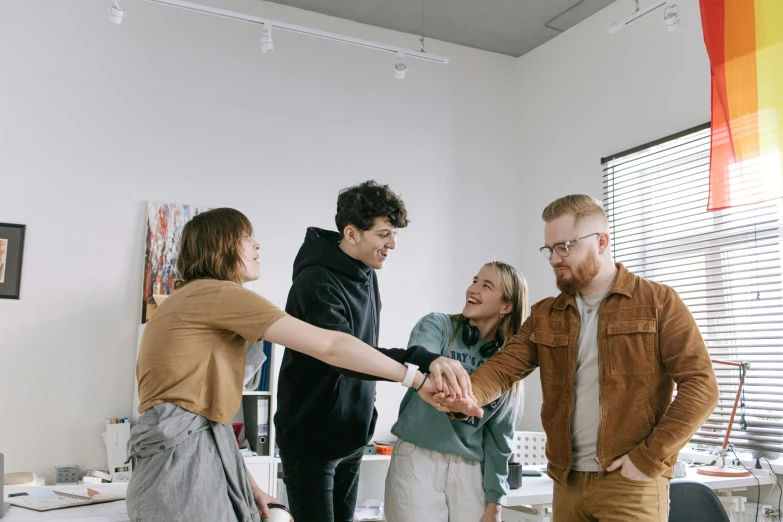 a group of people shaking hands in a room, fun pose, mental health, wearing casual clothing, artsationhq