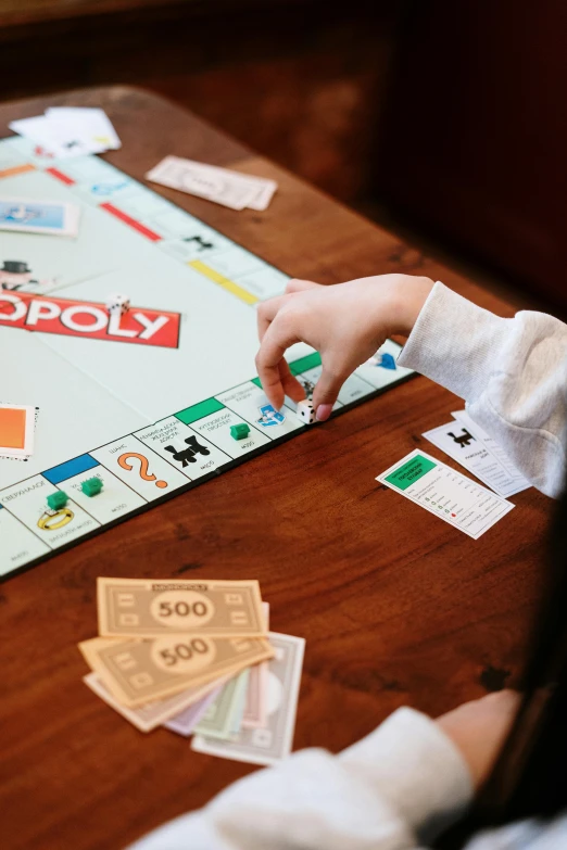 a child playing monopoly on a wooden table, by Julia Pishtar, unsplash, visual art, 15081959 21121991 01012000 4k, thumbnail, hollywood promotional image, charts