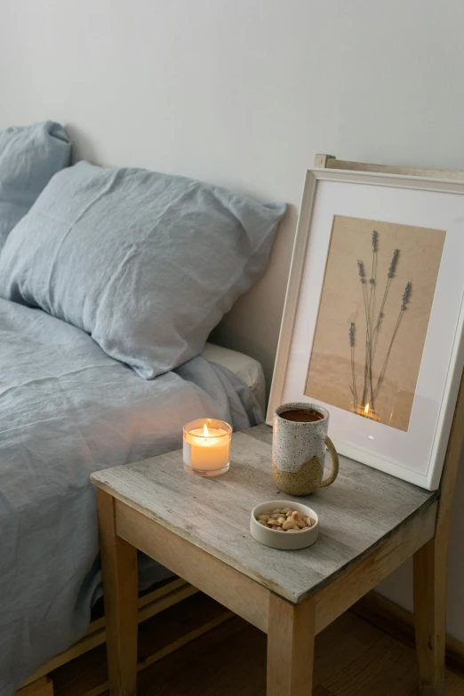 a bed room with a neatly made bed and a cup of coffee, inspired by Bedwyr Williams, featured on pinterest, visual art, candlelight, soft grey and blue natural light, framed in image, flax