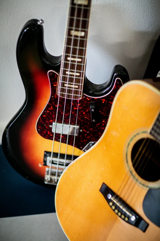 a couple of guitars sitting next to each other, double bass, up close, looking partly to the left