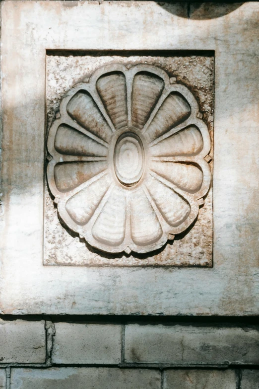 a fire hydrant sitting on top of a brick wall, a marble sculpture, inspired by Taddeo Gaddi, concrete art, centered radial design, silver，ivory, petals, ornate wood