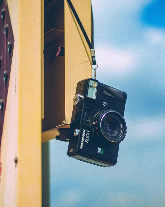 a camera attached to the side of a building, pexels contest winner, expired color film, looking up at camera, today\'s featured photograph 4k, flash photo