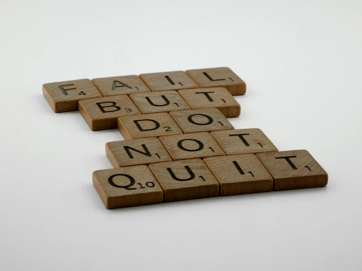 a scrabble that says fail but do not quit, by Felicity Charlton, dau-al-set, asset on grey background, brown, wooden, - 12p