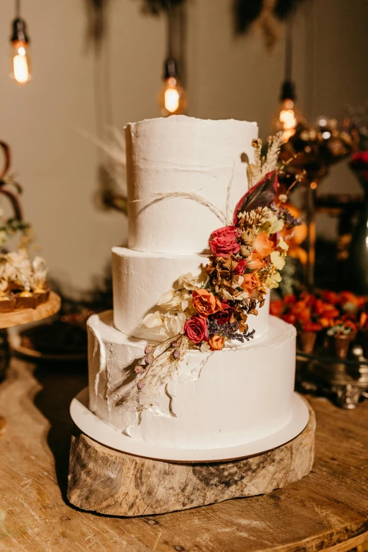 a white wedding cake sitting on top of a wooden table, unsplash, baroque, made of colorful dried flowers, beautifully lit, brown, full-body