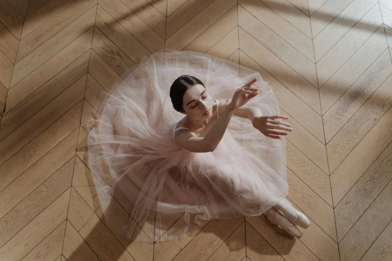 a woman in a tutu sitting on the floor, by Elizabeth Polunin, pexels contest winner, arabesque, in a sunbeam, lily collins, rituals, animation