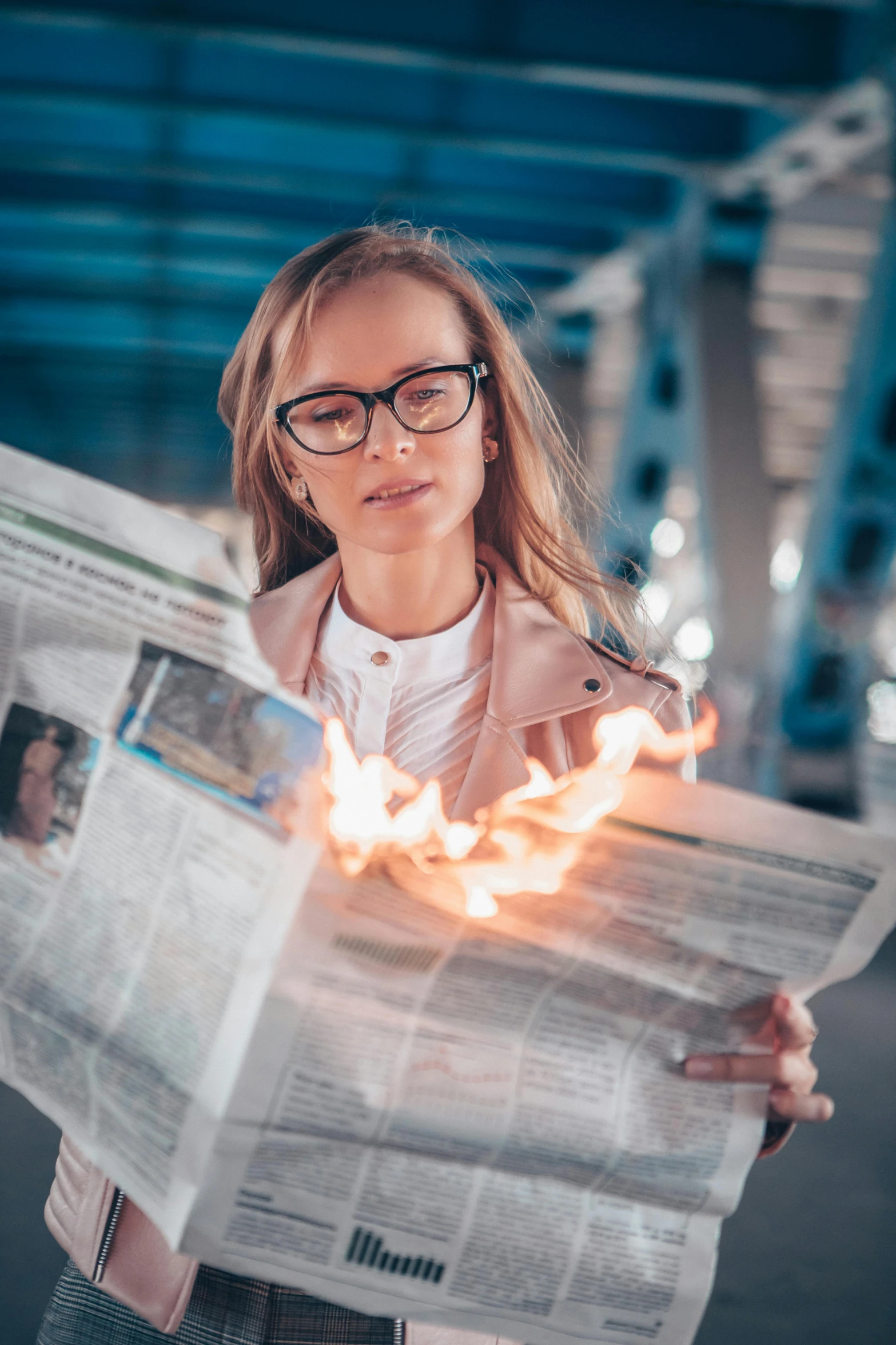 a woman holding a burning newspaper in her hands, by Adam Marczyński, pexels contest winner, girl wearing round glasses, instagram post, laser fire, high quality screenshot