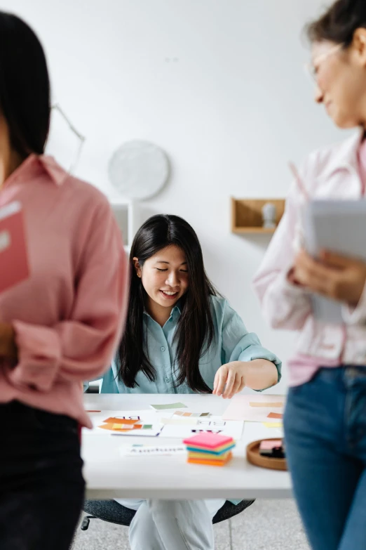 a group of people sitting around a table, a cartoon, by Jang Seung-eop, trending on unsplash, standing in class, asian woman made from origami, marketing photo, charts