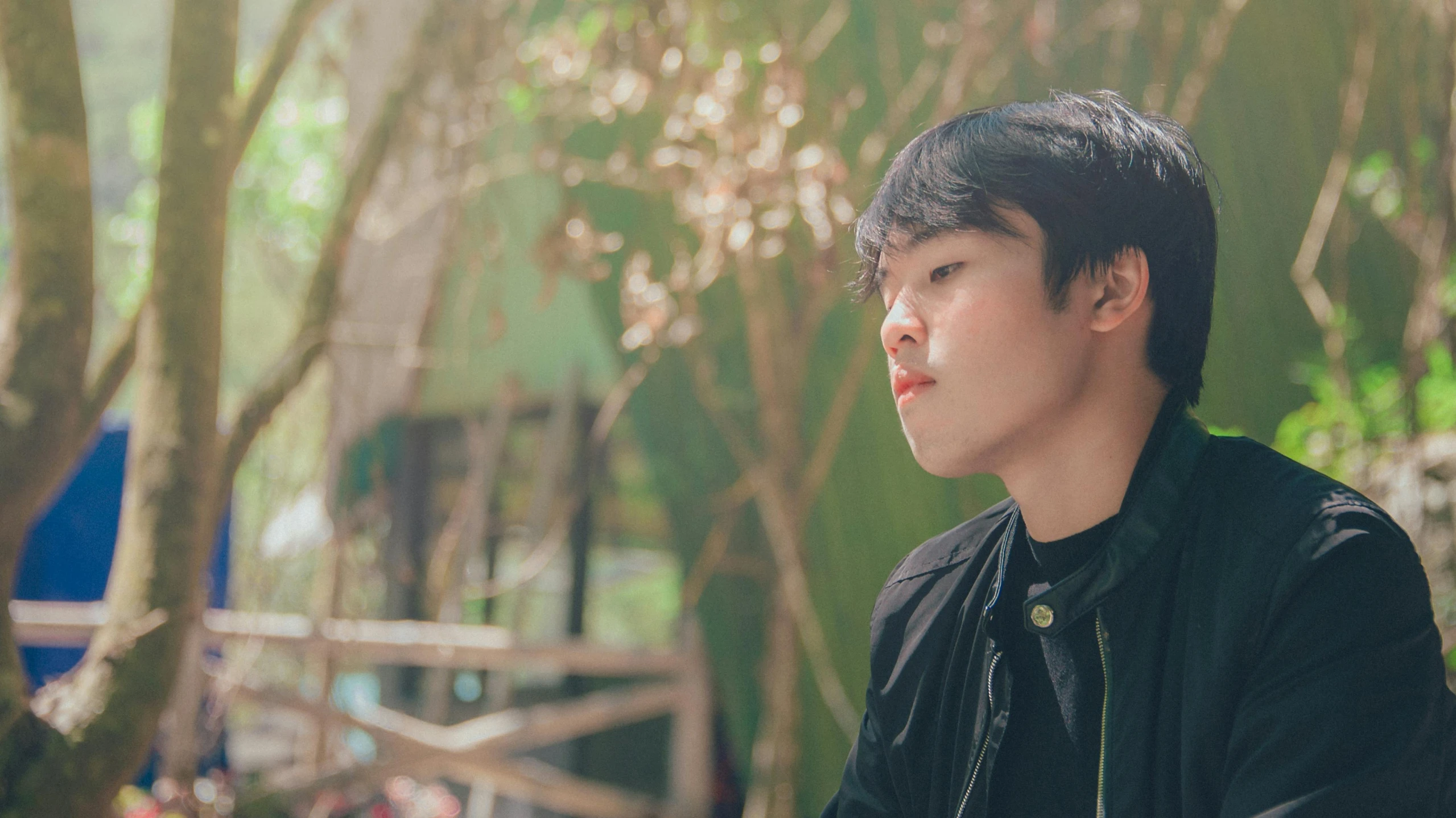 a man sitting on a bench next to a tree, inspired by Yeong-Hao Han, pexels contest winner, realism, jimin\'s plump lips, male teenager, headshot profile picture, amongst foliage