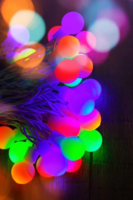 a bunch of colorful lights sitting on top of a wooden table