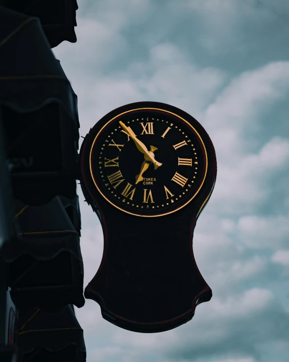 a clock hanging from the side of a building, profile image