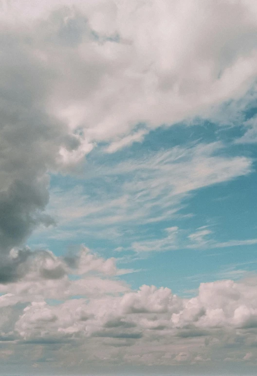 a man flying a kite on top of a lush green field, unsplash contest winner, aestheticism, layered stratocumulus clouds, light blues, grey, cotton candy clouds