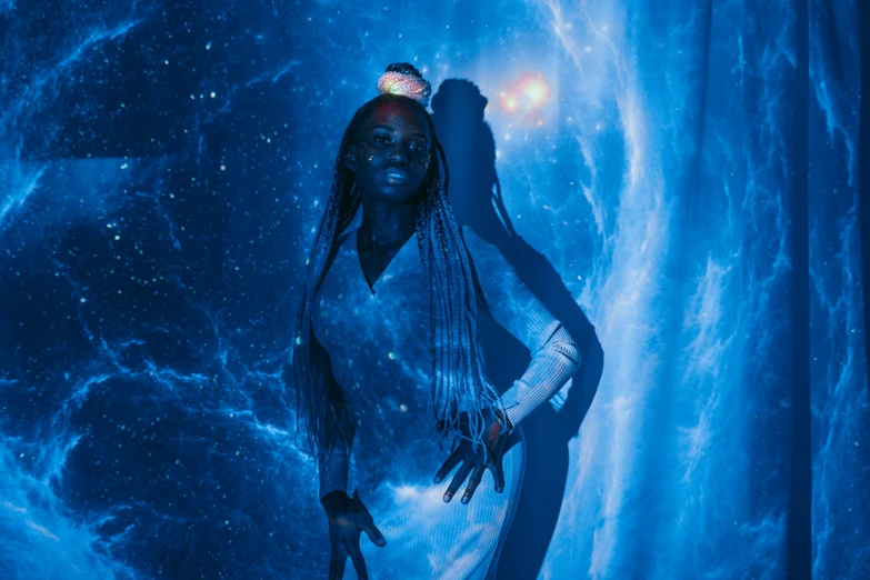 a woman with dreadlocks standing in front of a galaxy, pexels contest winner, afrofuturism, glowing blue interior components, ☁🌪🌙👩🏾, expert light effects on figure, black young woman