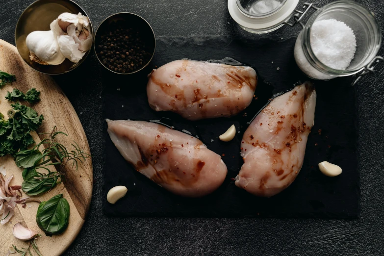 a bunch of meat sitting on top of a cutting board, by Julia Pishtar, trending on pexels, renaissance, chicken feathers, sparkling, on a gray background, 6 pack