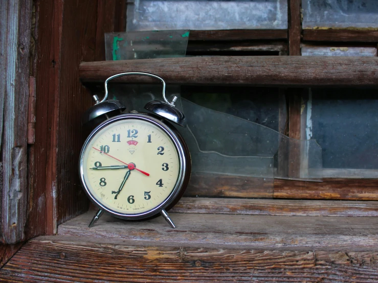 a black alarm clock sitting on a window sill, a portrait, unsplash, ((rust)), vintage old, a wooden, medium poly