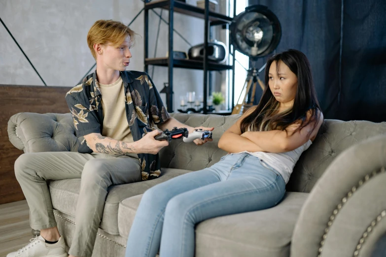 a man and a woman sitting on a couch playing a video game, by Adam Marczyński, trending on pexels, realism, man grabbing a womans waist, an asian woman, complaints, 😭🤮 💔