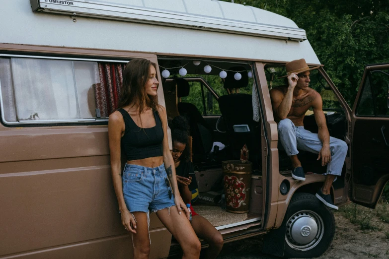a couple of women standing next to a van, pexels contest winner, renaissance, wearing a tank top and shorts, hippy, a group of people, camping