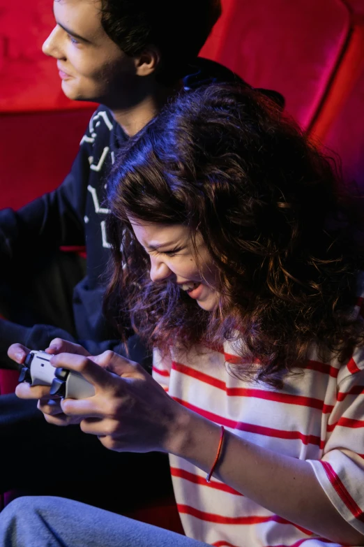 a man and a woman playing a video game, pexels, happening, rebecca sugar, she is holding a smartphone, red and cinematic lighting, smiling