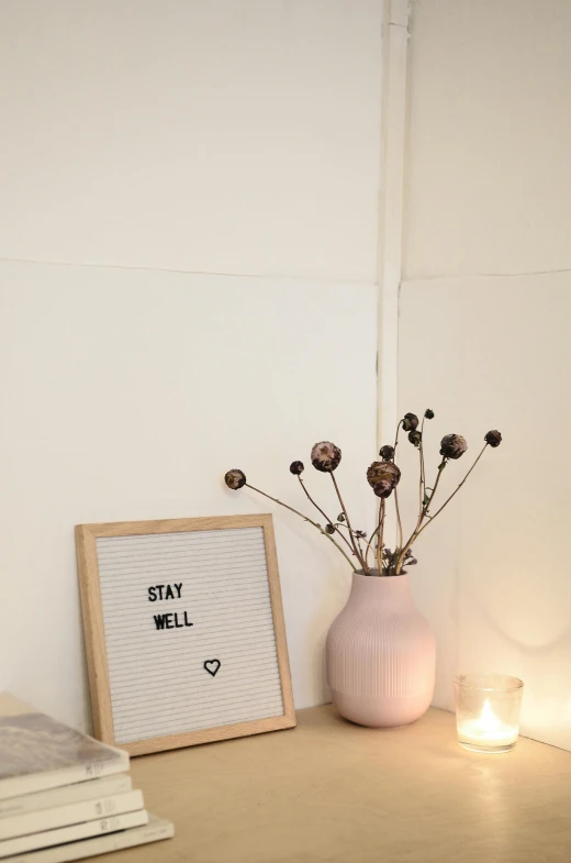 a pink vase sitting on top of a wooden table, a picture, pexels, dwell, sign, starry, cozy room