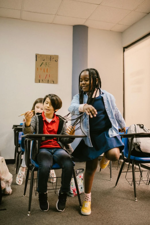 a group of children sitting at desks in a classroom, by Arabella Rankin, pexels contest winner, dancing with each other, meet the actor behind the scenes, alexis franklin, sitting on a lab table