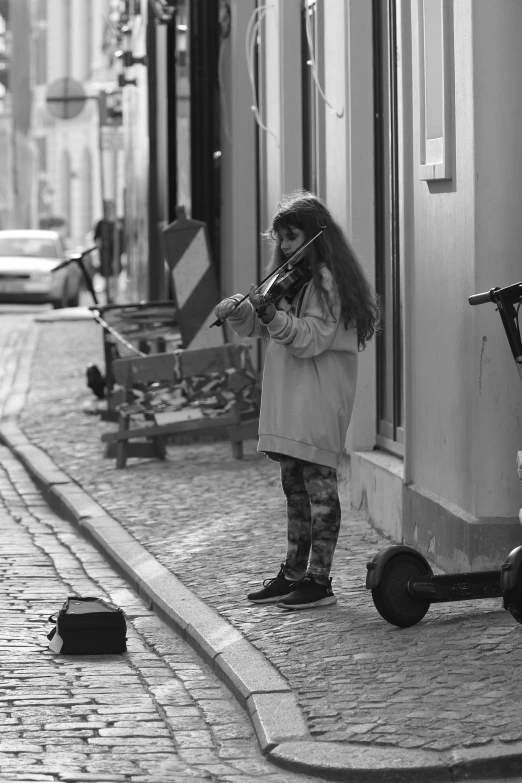 a black and white photo of a little girl playing the violin, by Altichiero, city morning, lisbon, photo taken in 2 0 2 0, (beautiful) girl