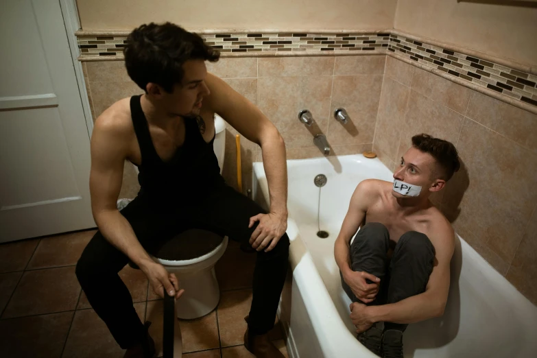 a man sitting on a toilet next to a man in a bathtub, inspired by Nan Goldin, renaissance, mouth shut, restrained, edmund blair and charlie bowater, premiere