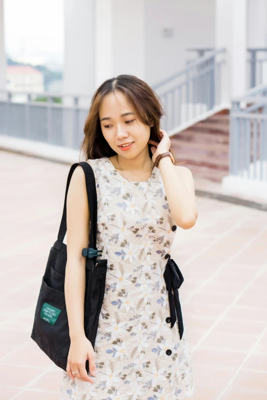 a woman standing on a sidewalk talking on a cell phone, by Tan Ting-pho, unsplash, flower butterfly vest, with a backpack, wearing : tanktop, ulzzang