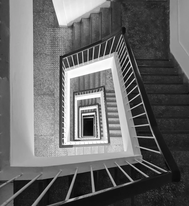 a black and white photo of a spiral staircase, inspired by MC Escher, unsplash contest winner, square, ilustration, stacked image, warsaw