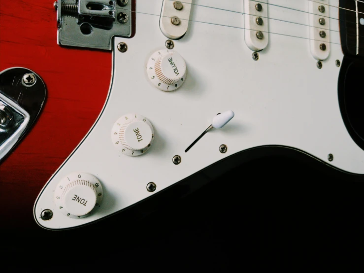 a close up of a red electric guitar, pexels contest winner, white mechanical details, tactile buttons and lights, a high angle shot, instagram post