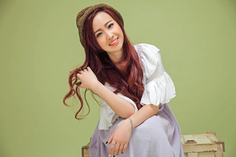 a beautiful young lady sitting on top of a suitcase, inspired by Kim Du-ryang, instagram, tachisme, brown red long hair, avatar image, malaysian, headshot profile picture