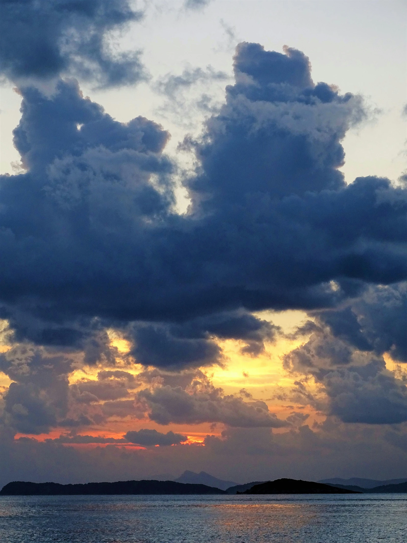 a large body of water under a cloudy sky, during a sunset, ((sunset)), towering cumulonimbus clouds, today\'s featured photograph 4k