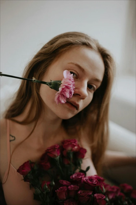 a woman with a flower sticking out of her nose, a picture, by Anna Boch, pexels contest winner, renaissance, sydney sweeney, attractive face and body, roses, non binary model