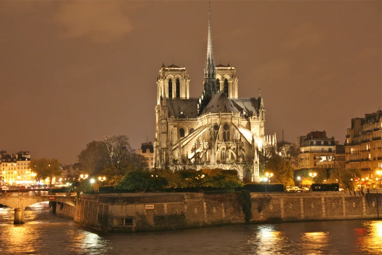 a large cathedral sitting on the side of a river, a photo, by Theo Constanté, night-time, slide show, jules julien, iconic