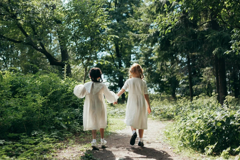 two little girls walking down a path holding hands, inspired by Kate Greenaway, unsplash, nico wearing a white dress, forest picnic, ignant, youtube thumbnail