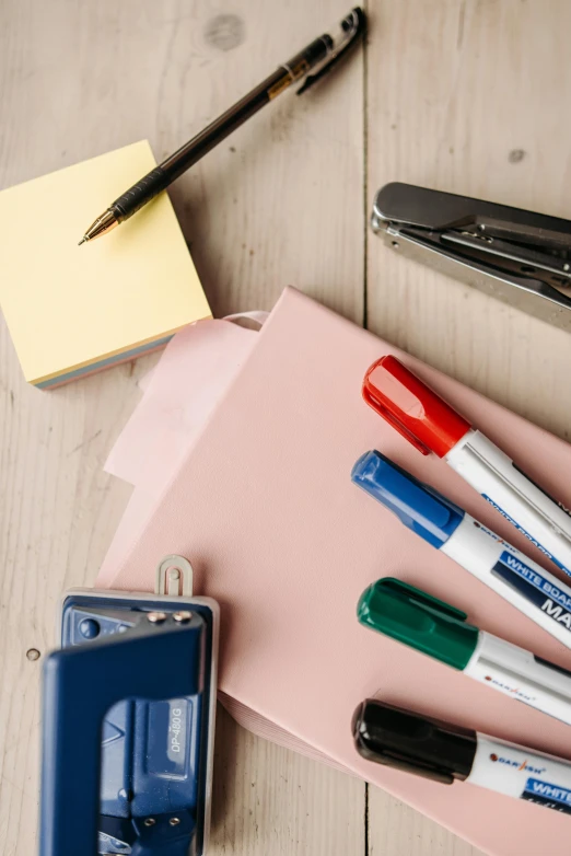 a group of office supplies sitting on top of a wooden table, square, thumbnail