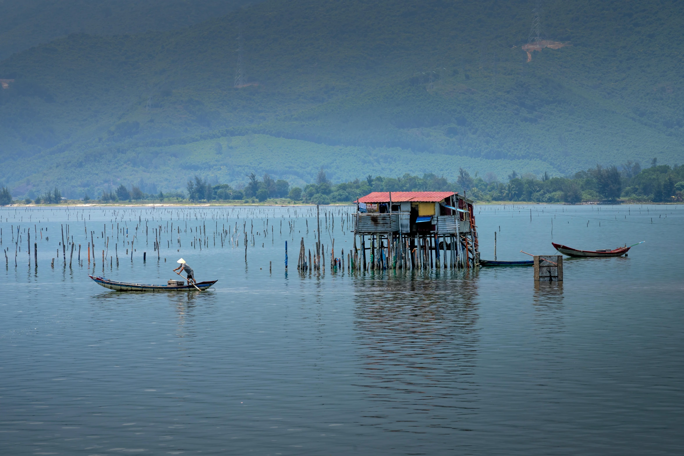 a couple of boats that are in the water, a picture, inspired by Steve McCurry, pexels contest winner, dau-al-set, bamboo huts, panoramic shot, phuoc quan, grey