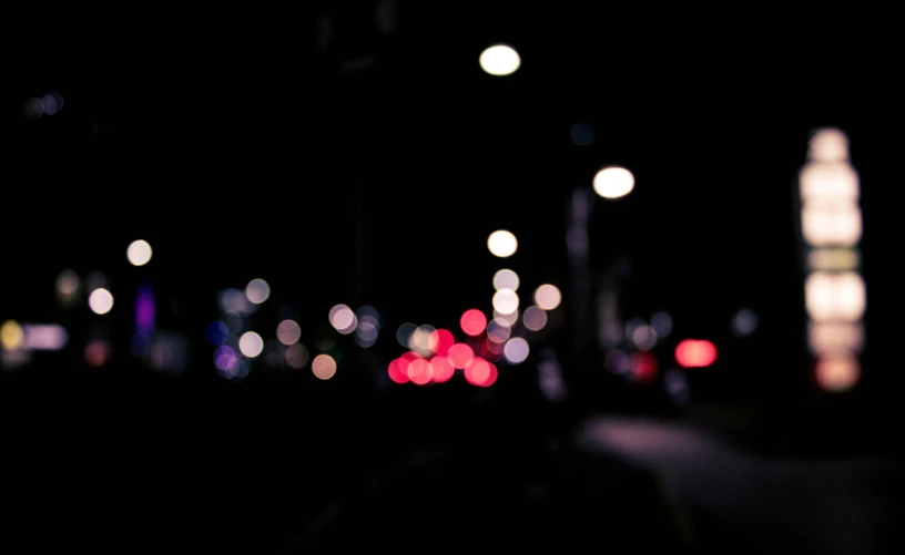 a city street filled with lots of traffic at night, unsplash, minimalism, hasselblad film bokeh, overcast bokeh - c 5, dark, multicoloured