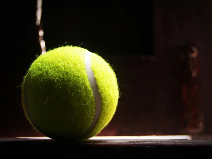 a tennis ball sitting on top of a table, by Julia Pishtar, pexels contest winner, back lit, 4 k hd wallpapear, an ancient, let's play