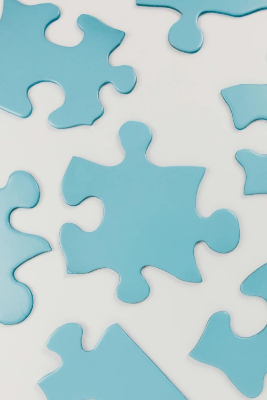 a pile of blue puzzle pieces on a white surface, curated collections, detailed product image, multiple stories, pastel'