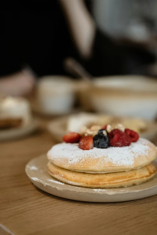 a stack of pancakes sitting on top of a wooden table, by Matthias Stom, trending on unsplash, japanese akihabara cafe, thumbnail, desserts, melbourne