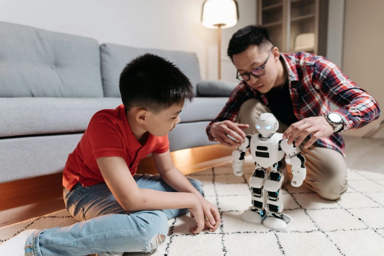 a man and a boy playing with a robot, pexels contest winner, ross tan, avatar image, teaching, father with child