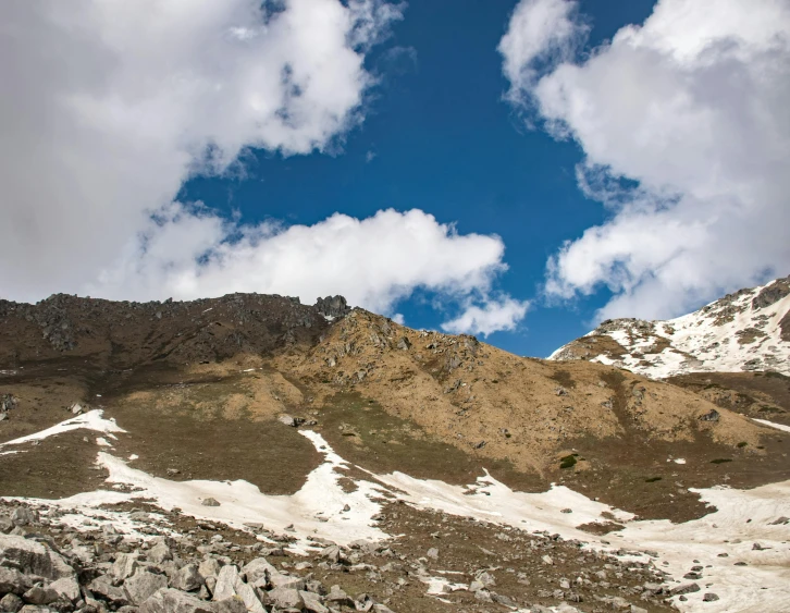 a man riding a snowboard down a snow covered slope, an album cover, trending on unsplash, les nabis, uttarakhand, hiking in rocky mountain, panorama view of the sky, thumbnail