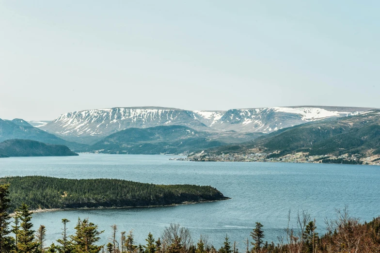 a large body of water surrounded by trees, by Brian Snøddy, les nabis, snowy fjord, hills and ocean, francois legault, high-resolution photo