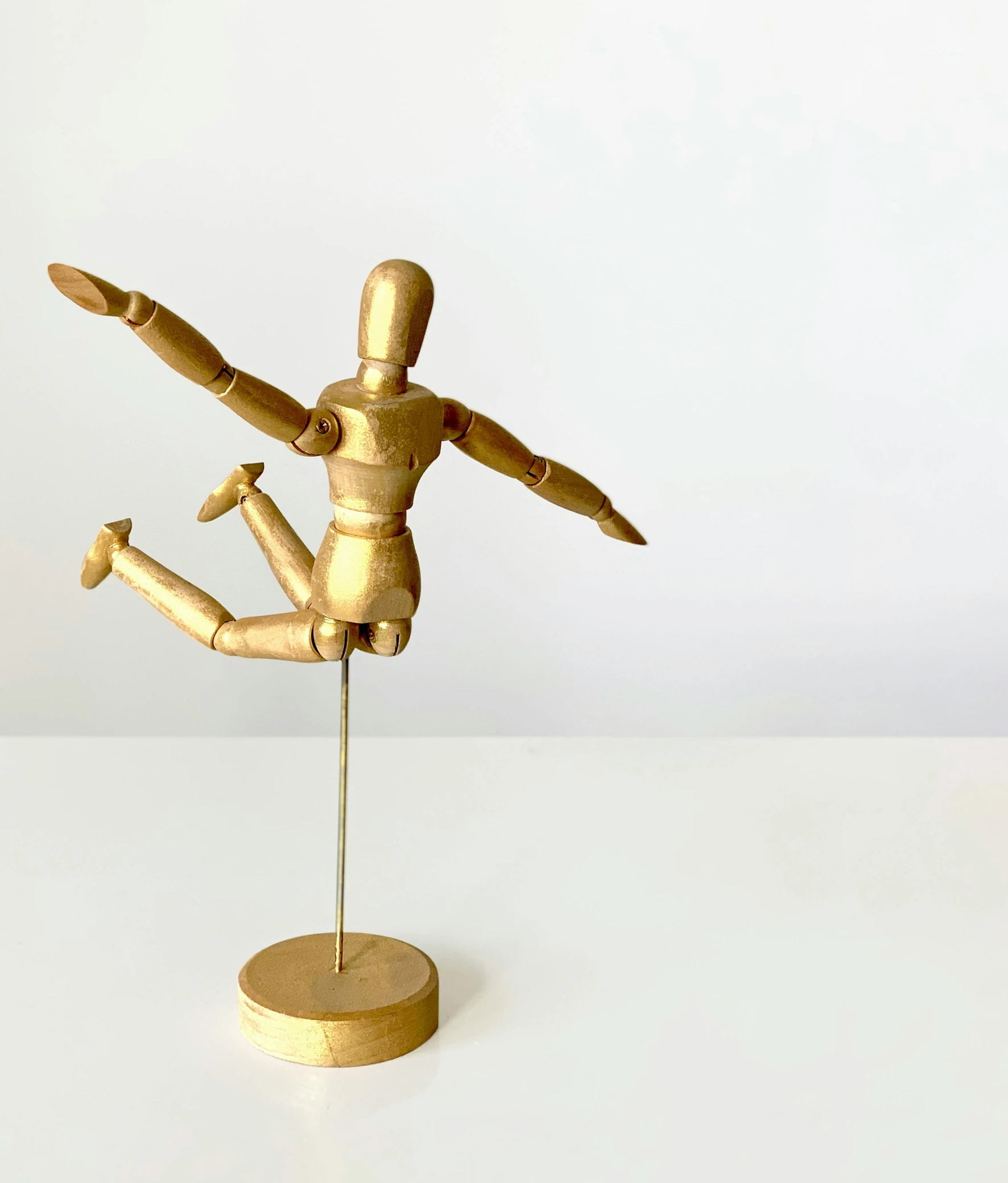 a wooden mannequin on a stand on a white surface, by Arabella Rankin, kinetic art, a boy made out of gold, kawaii playful pose of a dancer, vintage european folk art, singularity sculpted �ー etsy