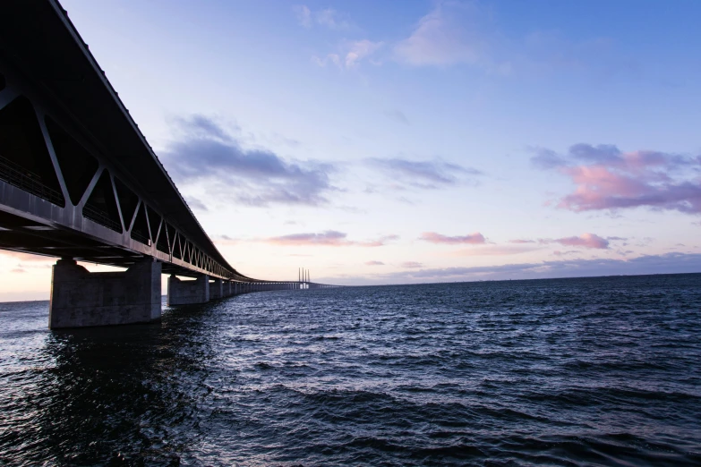 a bridge over a large body of water, an album cover, by Jesper Knudsen, unsplash, hurufiyya, under bridge, denmark, 2 5 6 x 2 5 6 pixels, view from the sea