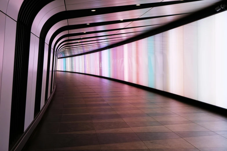 a long tunnel with a light at the end of it, inspired by Andreas Gursky, light and space, multicoloured, translucent pastel panels, london south bank, curved lines