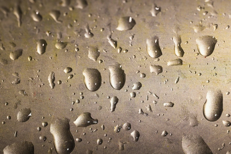 a close up of water droplets on a metal surface, inspired by Lucio Fontana, trending on pexels, photorealism, quixel megascans, metal shaded, metal floor, dark yellowish water